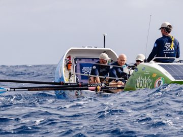 Team Seasoar rowing at sea.