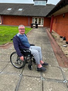 Chris Ward outside in his wheelchair.