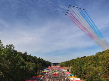 Great North Run runners with the Red Arrows ahead.