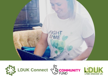 Natalie Hay wearing working on her laptop wearing Fight Lyme Now T-shirt.